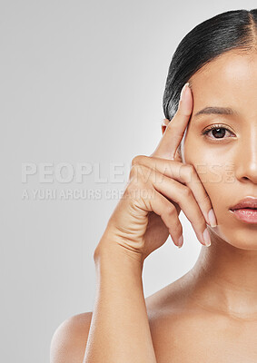 Buy stock photo Studio portrait of an attractive young woman posing against a grey background