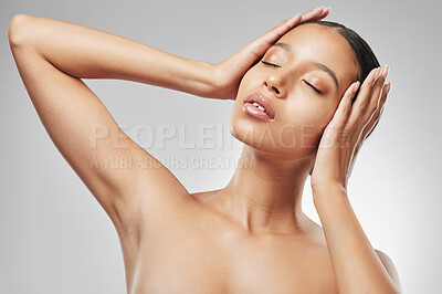 Buy stock photo Studio shot of an attractive young woman posing against a grey background