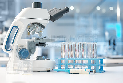 Buy stock photo Shot of an empty lab with a tray of test tubes and microscope on the table