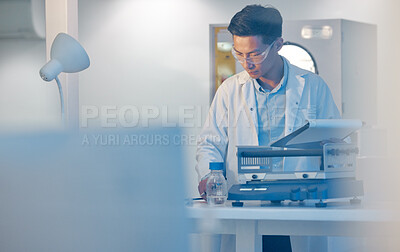 Buy stock photo Shot of a young male lab tech working in his office