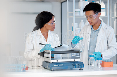 Buy stock photo Shot of two coworkers working together in a lab