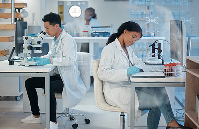 Buy stock photo Shot of a young woman making notes while working in a lab