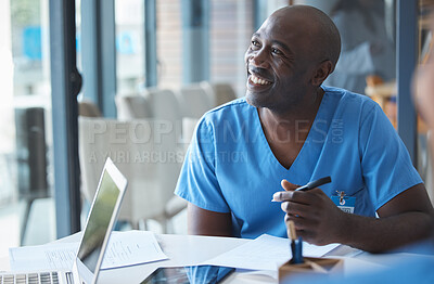 Buy stock photo Cropped shot of a handsome young male nurse sitting in the hospital boardroom during a meeting