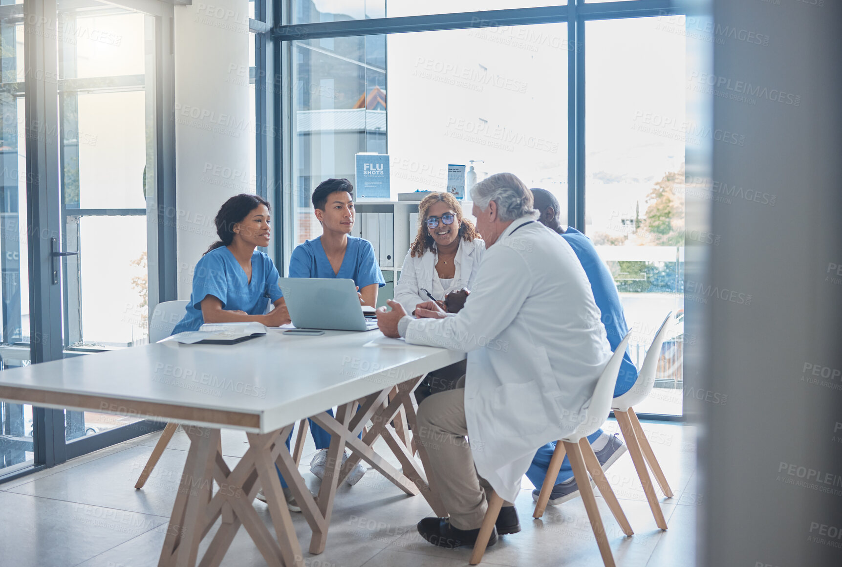 Buy stock photo Full length shot of a group a medical professionals sitting in the hospital boardroom during a meeting