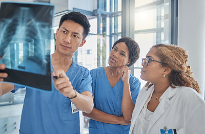 Buy stock photo Cropped shot of a group of medical professionals looking at an xray during a meeting in the hospital boardroom