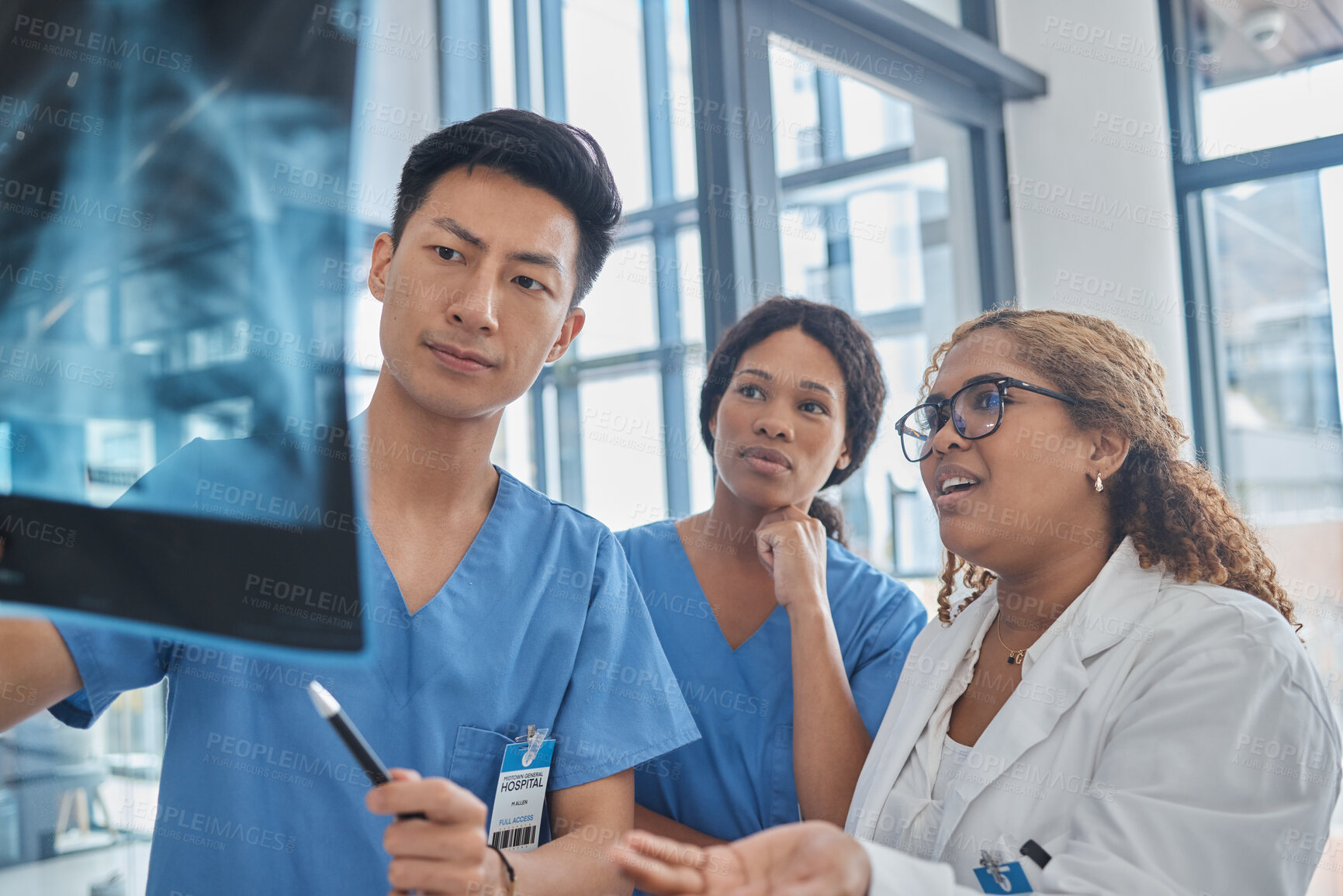 Buy stock photo Cropped shot of a group of medical professionals looking at an xray during a meeting in the hospital boardroom