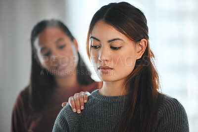 Buy stock photo Shot of a young woman helping her friend through a mental breakdown at home