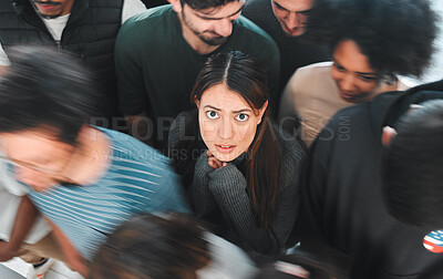 Buy stock photo Shot of a young woman experiencing mental illness while being surrounded by people inside