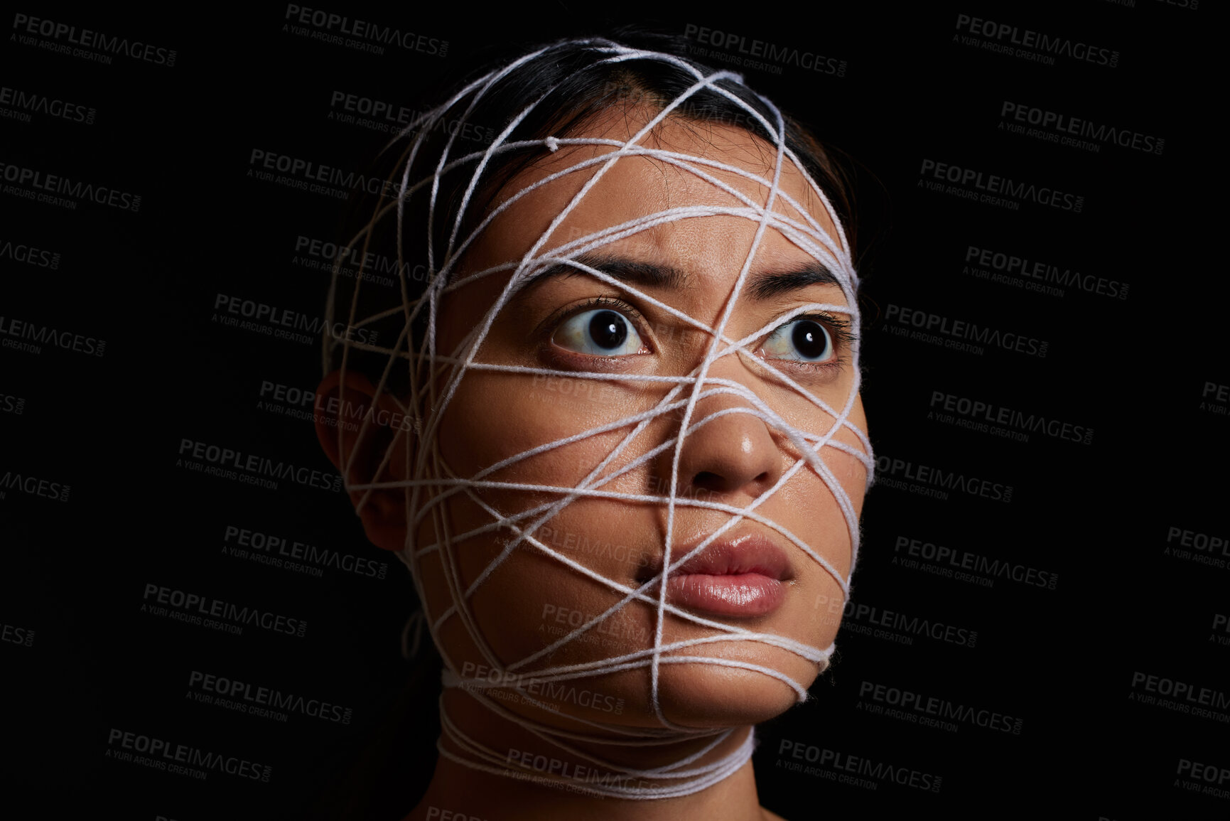 Buy stock photo Woman, rope and scared face for kidnapping, crime and danger with hostage, bondage and mental health. Female person, string and trapped in studio on black background for fear, violence and anxiety