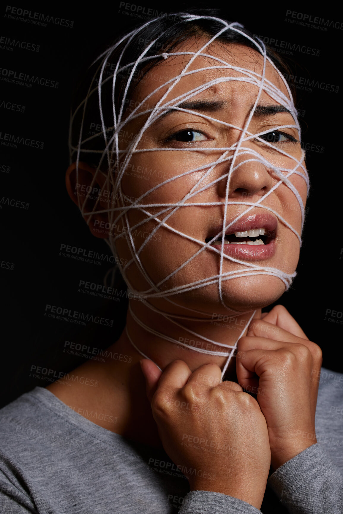 Buy stock photo Woman, rope and fear face for kidnapping, crime and danger with hostage, bondage and mental health. Female person, portrait and trapped in studio on black background for scared, violence and anxiety