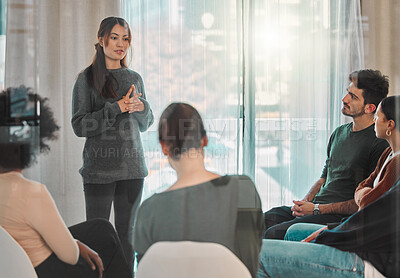 Buy stock photo Shot of a young woman talking during a group therapy session