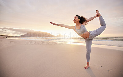 Buy stock photo Shot of a young woman practicing yoga on the beach