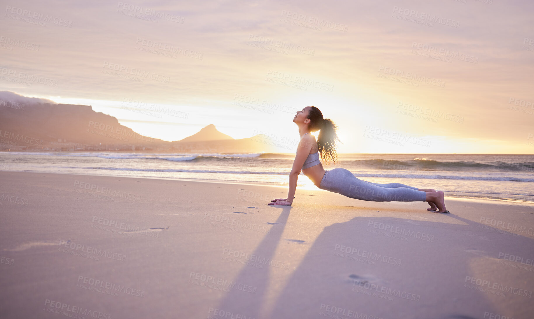 Buy stock photo Woman, fitness and yoga with beach sunset for pilates, workout or outdoor exercise in nature. Young, female person or yogi in warm up or stretching body for zen, awareness or wellness on ocean coast