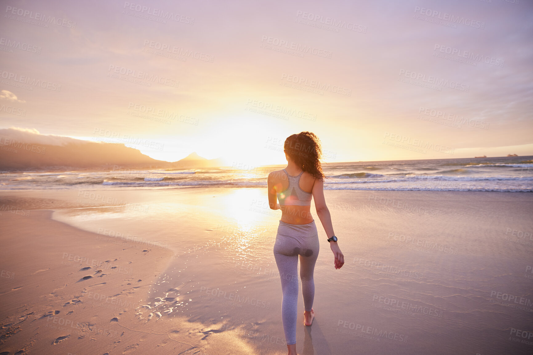 Buy stock photo Woman, back and fitness at beach, sunset and walking by shoreline, water and outdoor for exercise. Person, girl and runner by ocean for wellness, training and waves with sunshine at dusk in Colombia