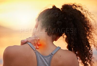 Buy stock photo Cropped shot of a woman experiencing shoulder pain during her workout