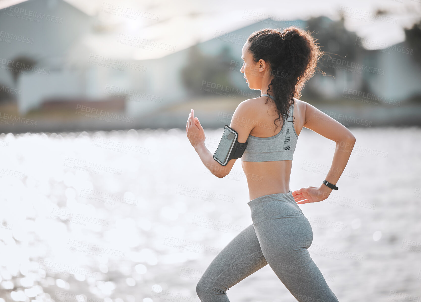 Buy stock photo Running, phone and woman on beach for exercise, marathon training and cardio workout. Sports, athlete and person in nature for performance, endurance and challenge for wellness, health and fitness