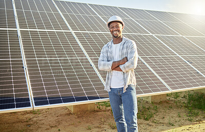 Buy stock photo Shot of a young man standing  in front of solar panel on a farm