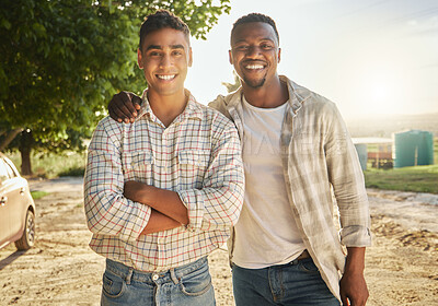 Buy stock photo Shot of two young farmers standing outside