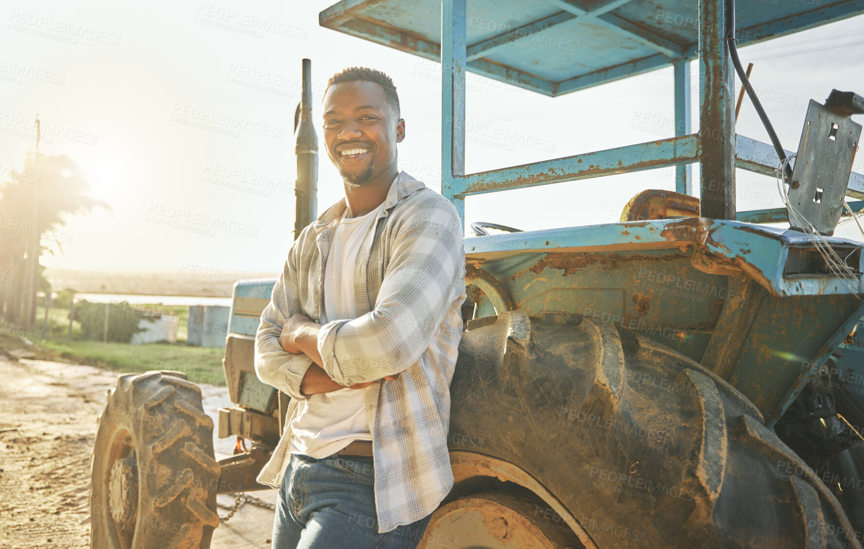 Buy stock photo Happy, tractor and portrait with black man on farm for quality inspection, sustainability and growth. Smile, agriculture and plant with person in Kenya countryside for nature, ecology and environment