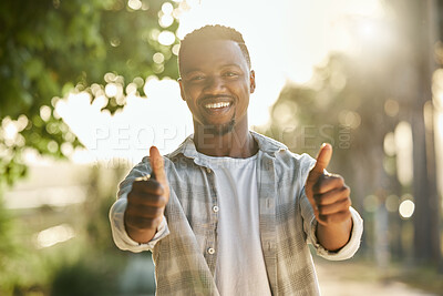 Buy stock photo Shot of a young man giving a thumbs up on a farm