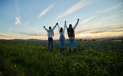 Buy stock photo Shot of three farmers standing on a farm during sunset
