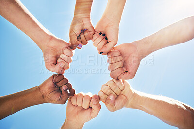 Buy stock photo Shot of a group of people with their hands joined in a circle during a protest
