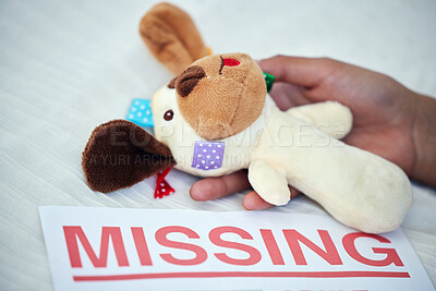 Buy stock photo Closeup shot of an unrecognisable woman holding a teddy bear alongside a missing person poster