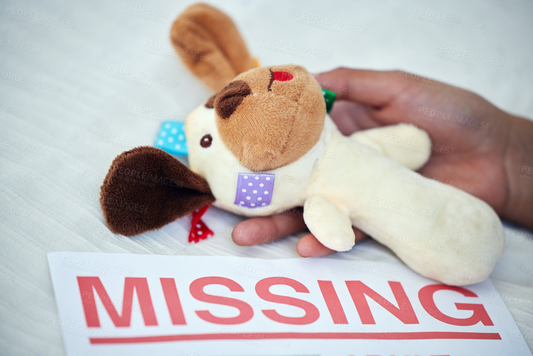 Buy stock photo Teddy bear, sign and missing person with hand on bed in house for depression, sad and mental health. Stuffed animal, poster and lost child with mother in bedroom for memory, crying and pain with fear