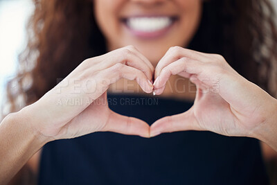 Buy stock photo Closeup shot of an unrecognisable woman making a heart shape with her hands