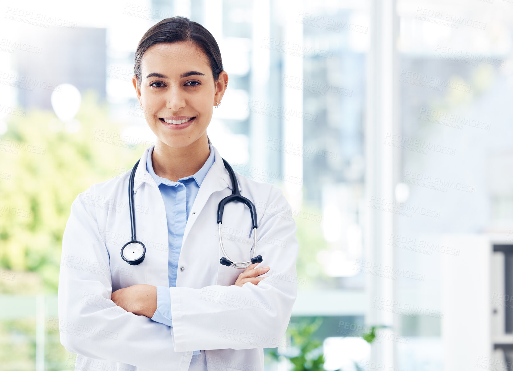 Buy stock photo Doctor, confident and portrait in hospital for healthcare,  medical advice and wellness with stethoscope. Woman, surgeon and crossed arms in clinic for job, experience and health with happiness