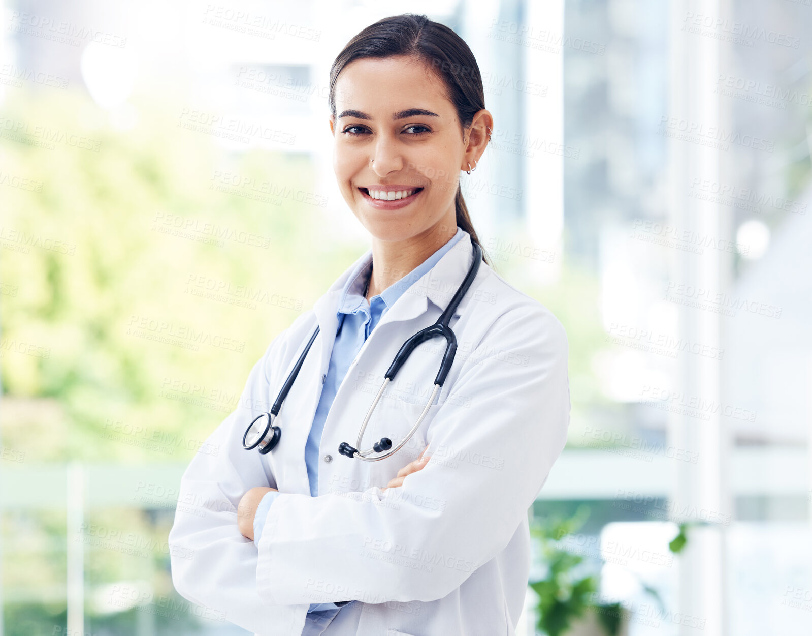 Buy stock photo Surgeon, confident and portrait in hospital for healthcare,  medical advice and wellness with stethoscope. Woman, doctor and crossed arms in clinic for job, experience and health with happiness