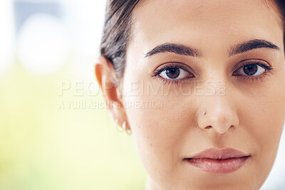 Buy stock photo Closeup shot of a young woman staring ahead of her