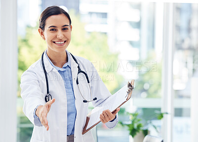 Buy stock photo Portrait of a young doctor extending a handshake in a hospital