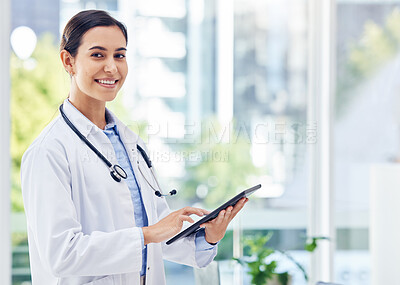 Buy stock photo Portrait of a young doctor using a digital tablet in a hospital
