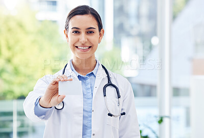 Buy stock photo Portrait of a young doctor holding a blank card in a hospital