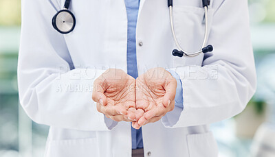 Buy stock photo Closeup shot of an unrecognisable doctor standing with her hands cupped together in a hospital