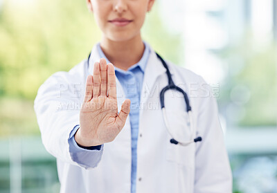 Buy stock photo Closeup shot of an unrecognisable doctor gesturing with her hand in a hospital