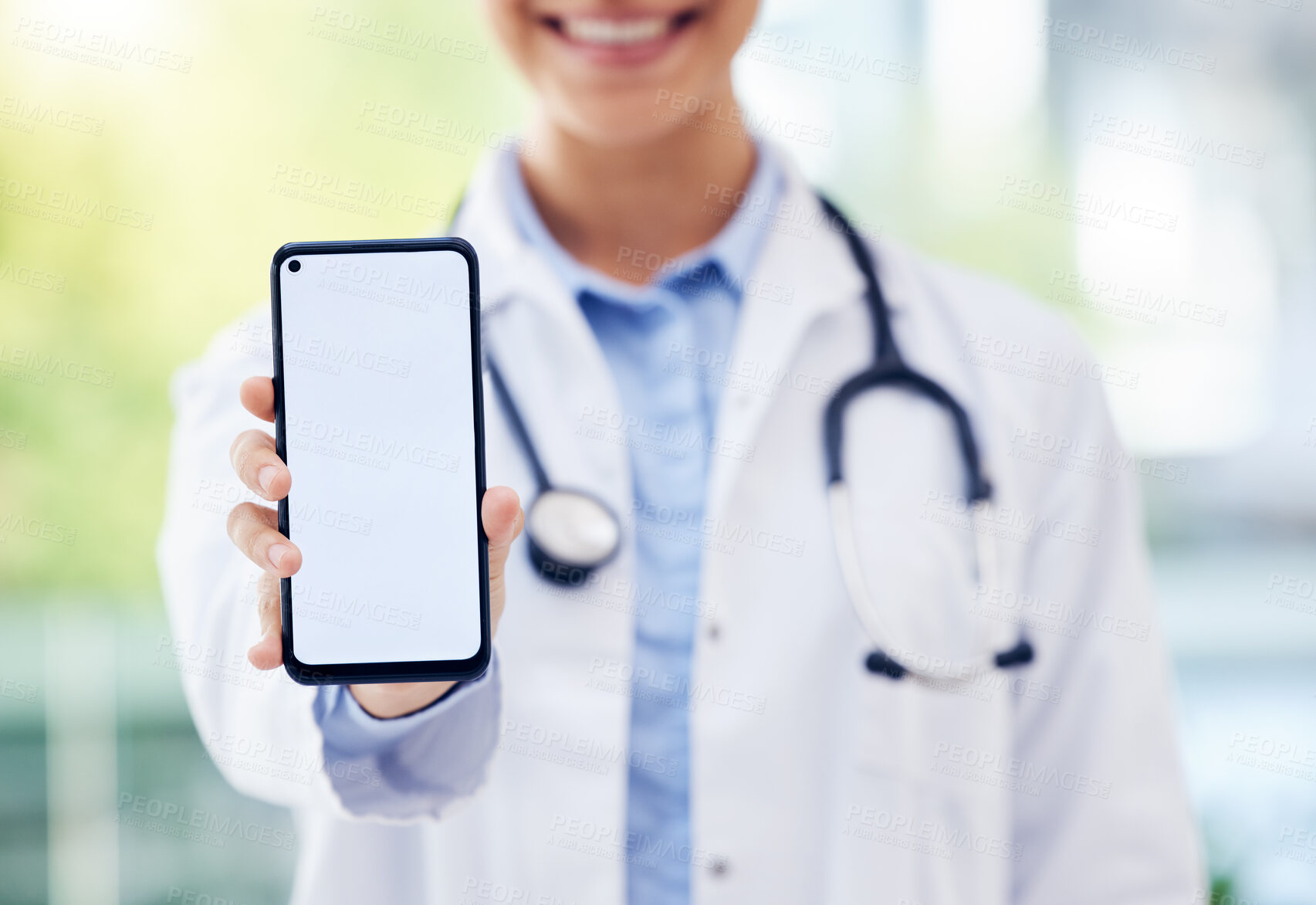 Buy stock photo Happy doctor, hands and advertising with phone screen for healthcare app, service or telehealth at hospital. Closeup of medical employee with mobile smartphone display or mockup space for online help