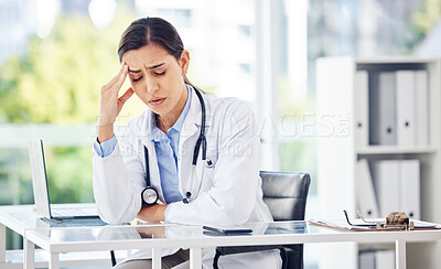 Buy stock photo Shot of a young doctor looking stressed out while working in a medical office