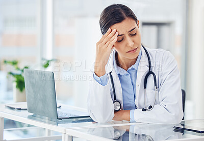 Buy stock photo Shot of a young doctor looking stressed out while working in a medical office