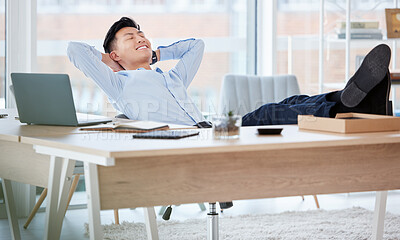 Buy stock photo Shot of a young businessman sleeping at his desk in an office