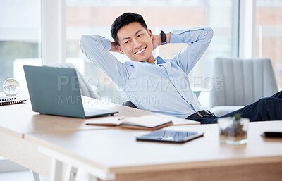 Buy stock photo Shot of a young businessman resting while working in a modern office