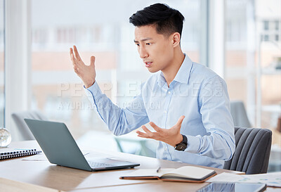 Buy stock photo Shot of a young businessman looking confused while working in an office