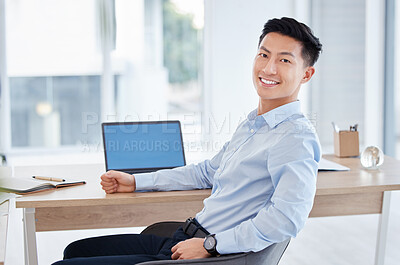 Buy stock photo Shot of a young businessman using a laptop at work