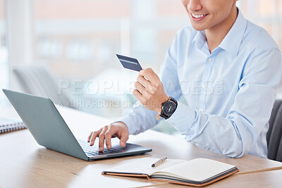 Buy stock photo Shot of an unrecognizable businessperson using a laptop and credit card at work