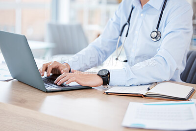Buy stock photo Shot of an unrecognizable doctor using a laptop in an office at a hospital