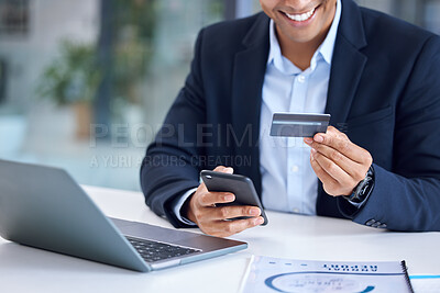 Buy stock photo Closeup shot of an unrecognisable businessman using a cellphone and credit card in an office