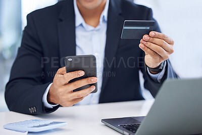Buy stock photo Closeup shot of an unrecognisable businessman using a cellphone and credit card in an office