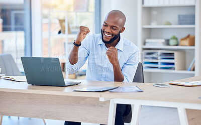 Buy stock photo Shot of a young businessman cheering while using a laptop in a modern office at work
