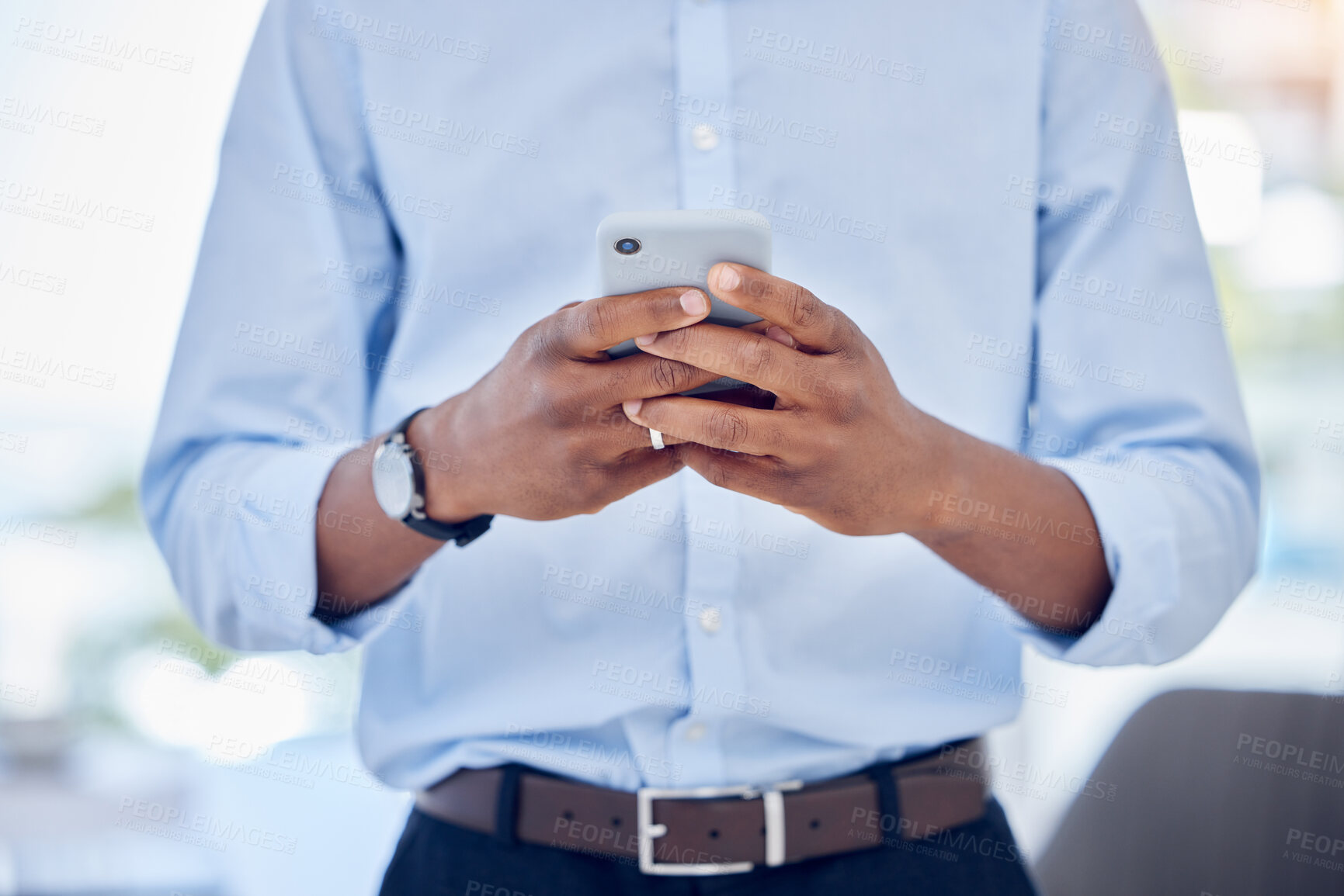 Buy stock photo Shot of an unrecognizable businessperson using a phone at work